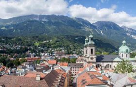 This is a landscape image of the perspective of buildings in Europe. Here we see a view of the terracotta roofs of Europe with the Alps in the background. By Cademix Institute of Technology, Cademix Magazine